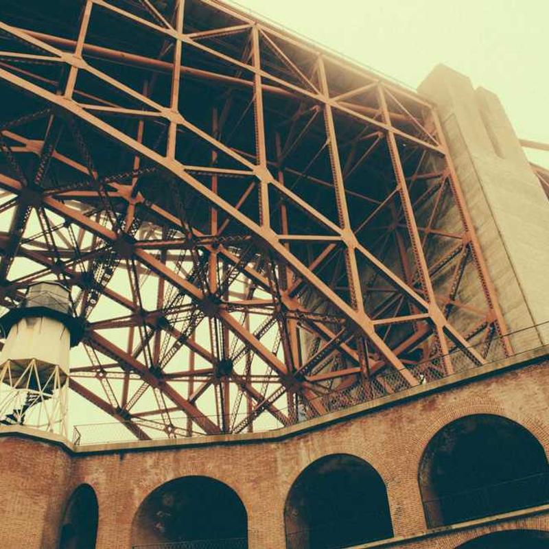 Placeholder. Shot from the ground, looking upwards, a very washed image of a nondescript structure.