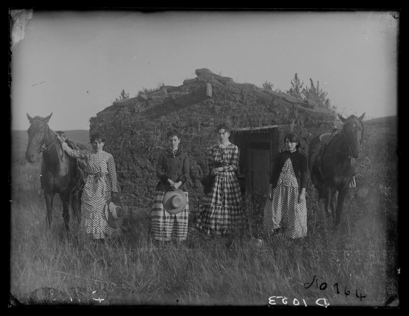 Chrisman sisters, 1886, in front of their sod house in Nebraska